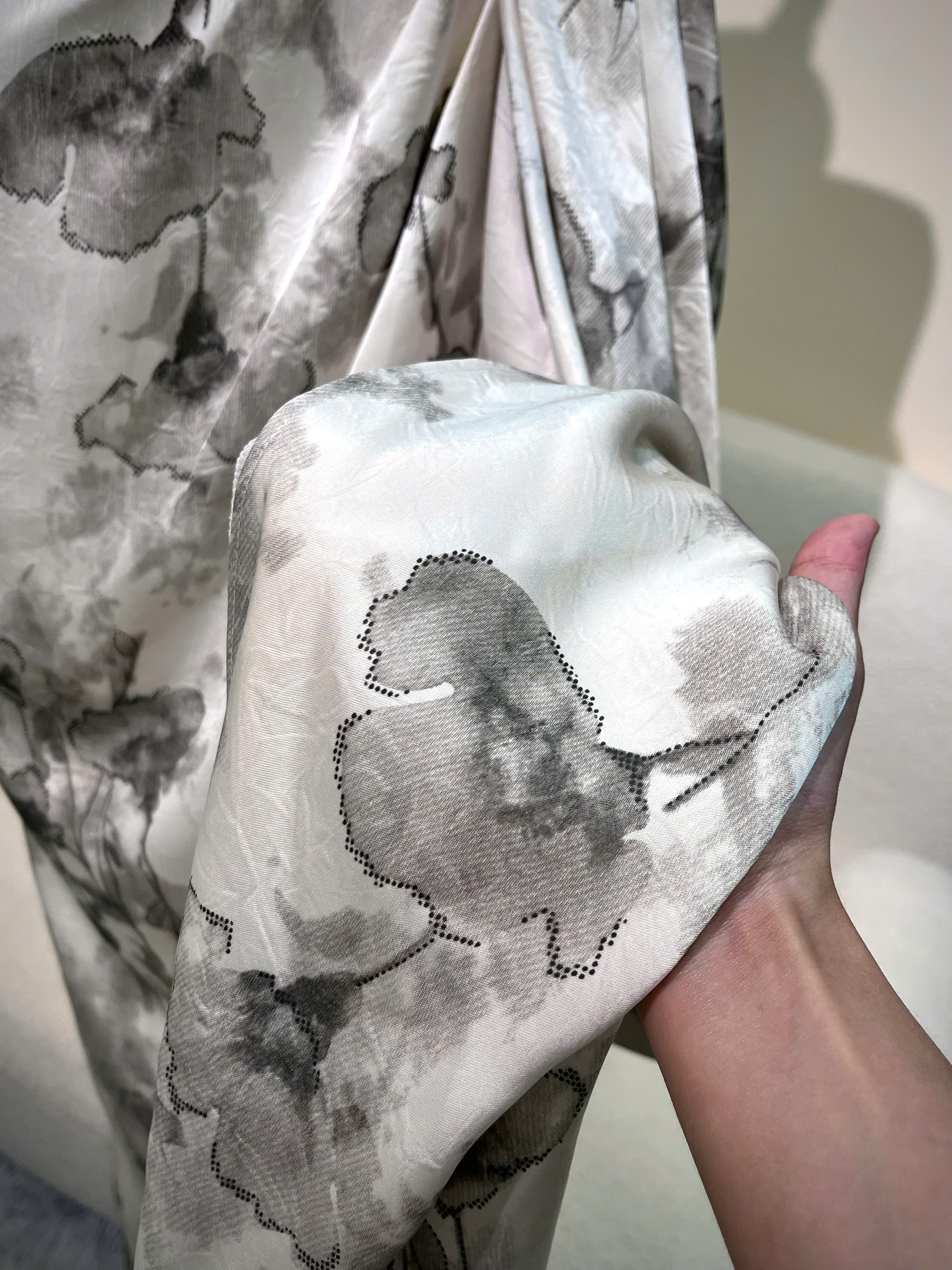 Close-up of grey floral silk fabric for a custom bridesmaid dress in Singapore